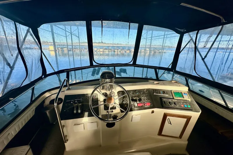 Slide: The Image of Interior view of 1989 Carver 38 Aft Cabin Motor Yacht helm with panoramic windows. - 6