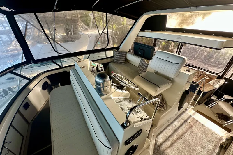 Slide: The Image of 1989 Carver 38 Aft Cabin Motor Yacht interior with helm and seating area. - 7