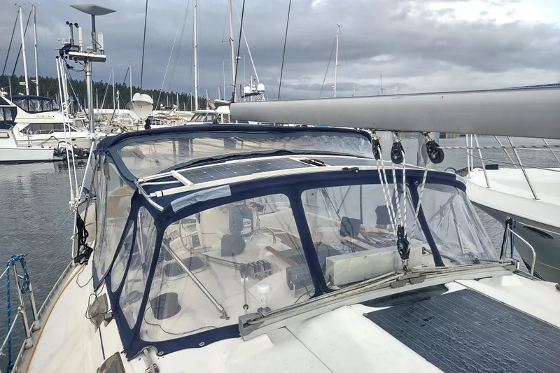 Slide: The Image of Beneteau Moorings 445 sailboat, 1993 model, docked in a marina under cloudy skies. - 10