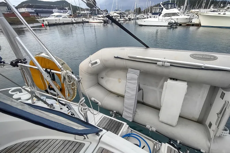 Slide: The Image of Sailboat Beneteau Moorings 445, 1993 model, docked with inflatable dinghy in marina. - 12