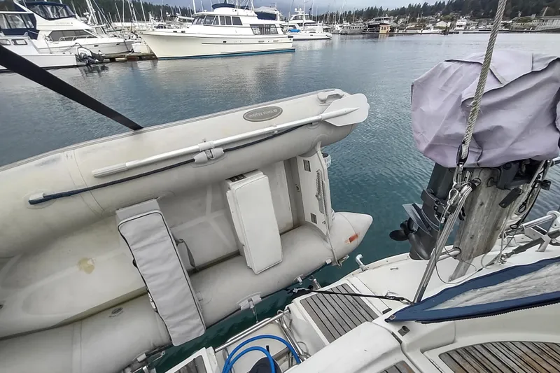 Slide: The Image of Inflatable dinghy on a 1993 Beneteau Moorings 445 yacht in a marina. - 13