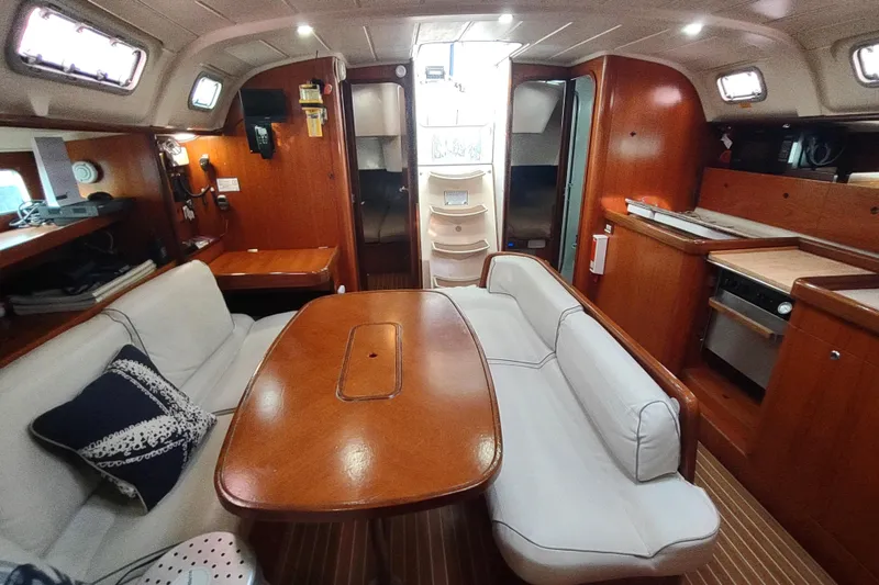 Slide: The Image of Interior of 1993 Beneteau Moorings 445 yacht with cozy seating and wooden finishes. - 23
