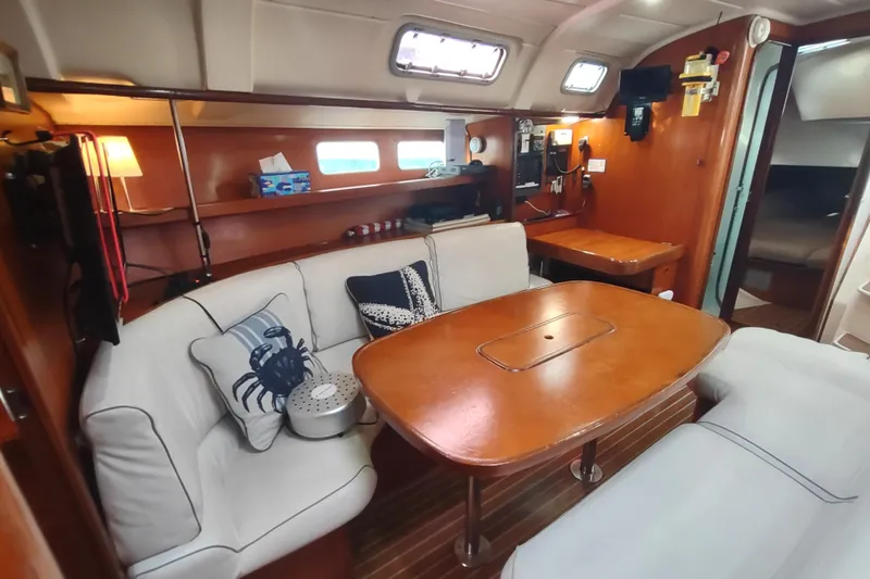 Slide: The Image of Interior of 1993 Beneteau Moorings 445 yacht with kitchen, seating, and wood finish. - 25