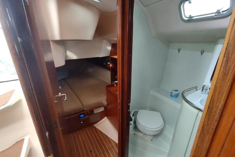 Slide: The Image of Interior of 1993 Beneteau Moorings 445 yacht with wooden furnishings and cozy seating. - 26