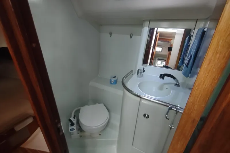 Slide: The Image of Interior of 1993 Beneteau Moorings 445 yacht with wooden cabinetry and white seating. - 27