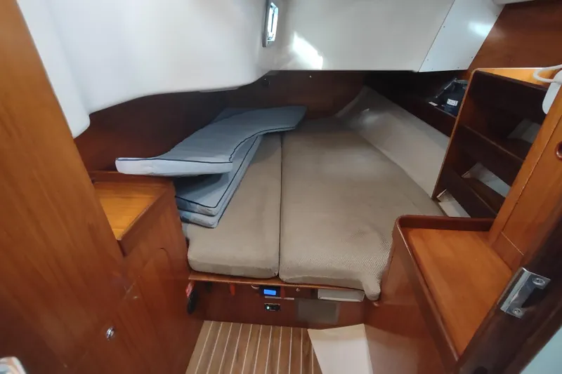 Slide: The Image of Interior of 1993 Beneteau Moorings 445 yacht with cozy seating and wooden table. - 28