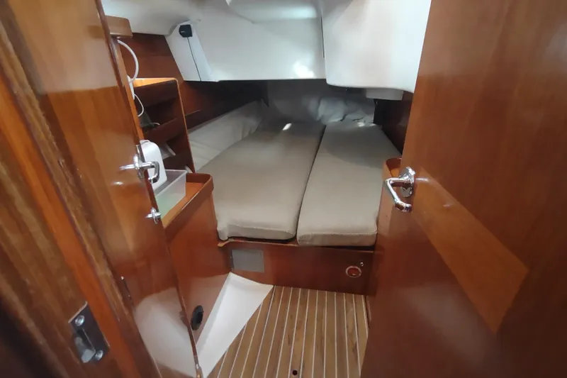 Slide: The Image of Cozy cabin interior of 1993 Beneteau Moorings 445 sailboat with wooden finish and cushions. - 31