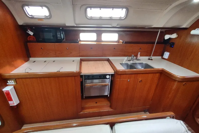 Slide: The Image of Cozy cabin interior of 1993 Beneteau Moorings 445 sailboat with wooden finish. - 34