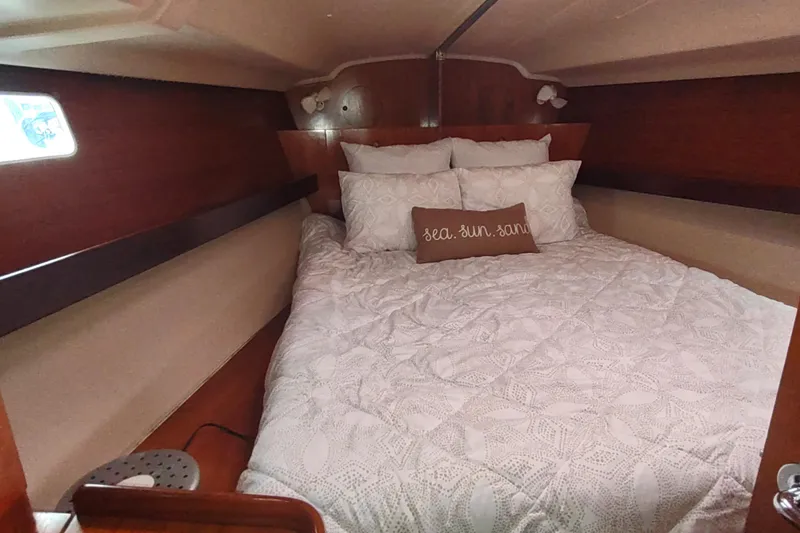 Slide: The Image of Cozy cabin interior of 1993 Beneteau Moorings 445 sailboat with plush bedding. - 48