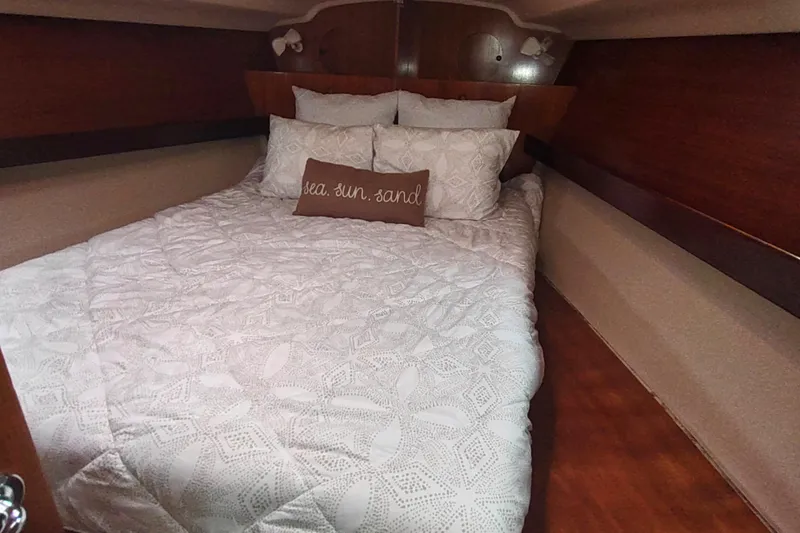 Slide: The Image of Cozy cabin interior of 1993 Beneteau Moorings 445 with decorative pillows. - 49