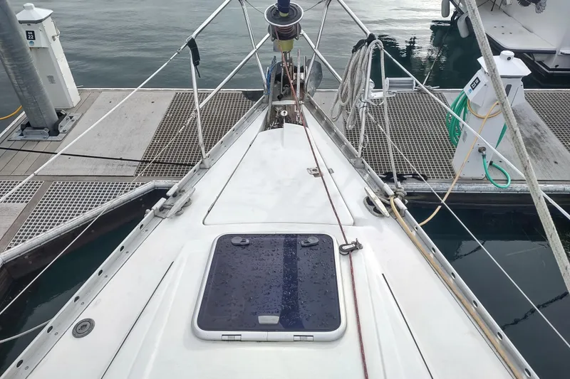 Slide: The Image of Bow view of 1993 Beneteau Moorings 445 sailboat docked at marina. - 5