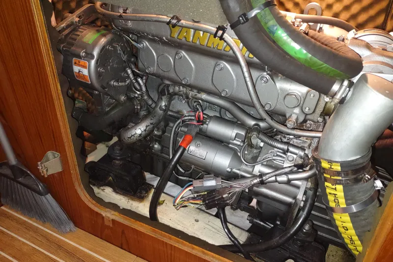 Slide: The Image of Engine compartment of a 1993 Beneteau Moorings 445 sailboat, featuring a Yanmar engine. - 51