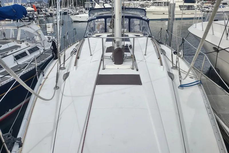 Slide: The Image of 1993 Beneteau Moorings 445 sailboat docked in a marina, surrounded by other boats. - 7