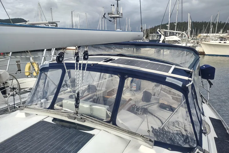 Slide: The Image of 1993 Beneteau Moorings 445 sailboat with solar panels docked in a marina. - 8