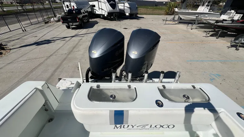 Slide: The Image of 2005 Contender 36 Open boat with dual outboard engines in a marina. - 12