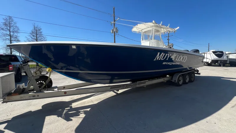 Slide: The Image of 2005 Contender 36 Open boat on a trailer in a parking lot. - 5