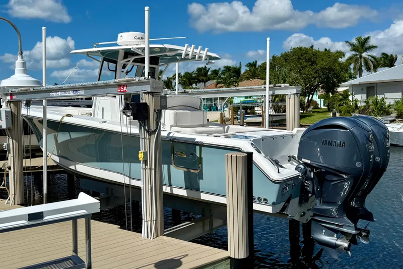 The Image of 2021 Sea Hunt Gamefish 30 boat cruising on calm waters under a clear sky. - 1