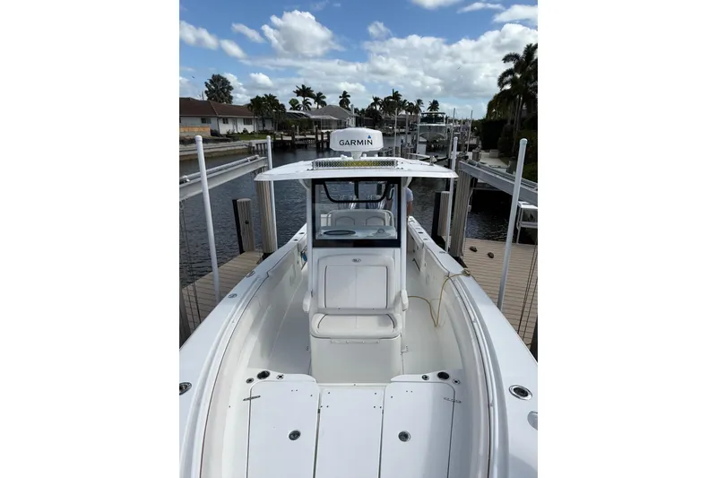 Slide: The Image of 2021 Sea Hunt Gamefish 30 boat with forward seating on a sunny day by the water. - 15