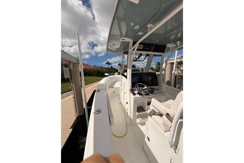 Slide: The Image of 2021 Sea Hunt Gamefish 30 Forward Seating boat on calm water, sunny day. - 21