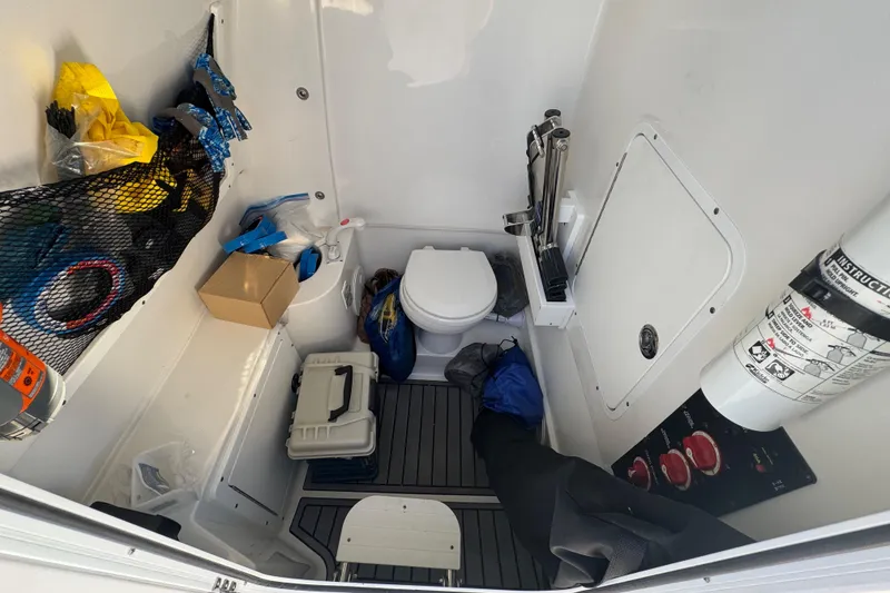 Slide: The Image of Interior of 2021 Sea Hunt Gamefish 30, featuring storage and marine toilet. - 33