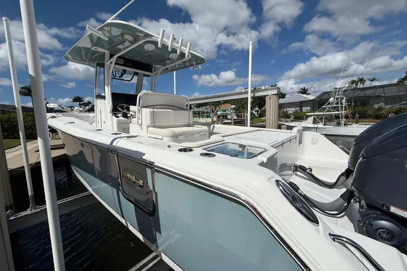 Slide: The Image of 2021 Sea Hunt Gamefish 30 boat with dual engines on calm water. - 6