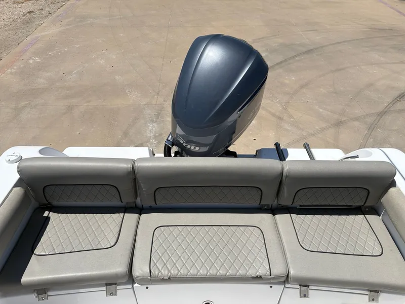 Slide: The Image of 2021 Sportsman Heritage 241 Center Console boat with cushioned seating and outboard motor. - 11