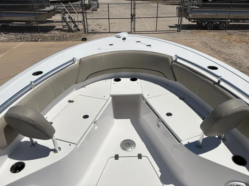 Slide: The Image of 2021 Sportsman Heritage 241 Center Console boat interior with cushioned seating and storage compartments. - 27