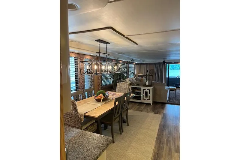 Slide: The Image of Interior of 1995 Sumerset houseboat, featuring dining and living area with modern decor. - 11