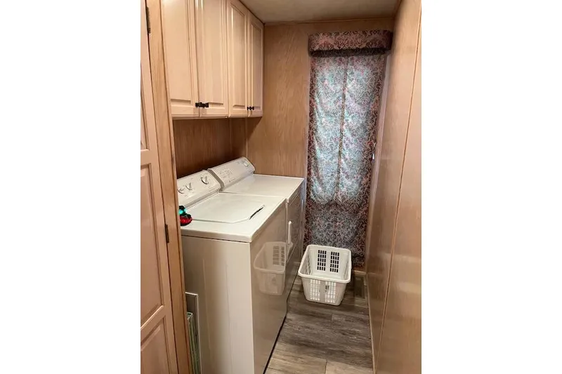 Slide: The Image of Laundry room in 1995 Sumerset 19.5 x 95 houseboat with washer, dryer, and storage cabinets. - 13