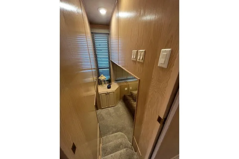 Slide: The Image of Narrow hallway in a 1995 Sumerset houseboat with wooden walls and carpeted stairs. - 18