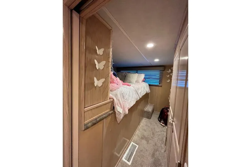 Slide: The Image of Cozy bedroom in 1995 Sumerset houseboat with butterfly decor and soft lighting. - 19