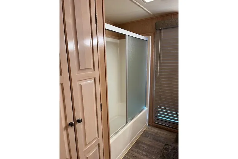 Slide: The Image of Bathroom with sliding glass shower doors in a 1995 Sumerset 19.5 x 95 houseboat. - 21