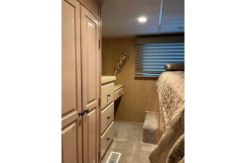 Slide: The Image of Cozy interior of 1995 Sumerset houseboat with wooden cabinets and carpeted flooring. - 22