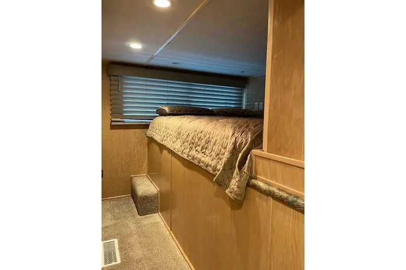 Slide: The Image of Cozy bedroom interior in 1995 Sumerset 19.5 x 95 houseboat with wooden paneling. - 23