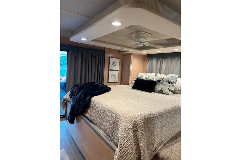 Slide: The Image of Cozy bedroom interior in a 1995 Sumerset 19.5 x 95 houseboat with elegant decor. - 28