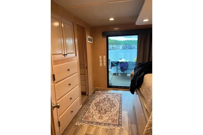 Slide: The Image of Interior of 1995 Sumerset houseboat with wooden cabinets, rug, and lake view. - 29