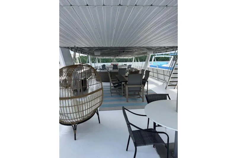Slide: The Image of Spacious deck of 1995 Sumerset 19.5 x 95 houseboat with outdoor seating and wicker chair. - 31