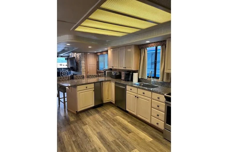 Slide: The Image of Spacious kitchen in 1995 Sumerset houseboat, featuring modern appliances and wooden flooring. - 9