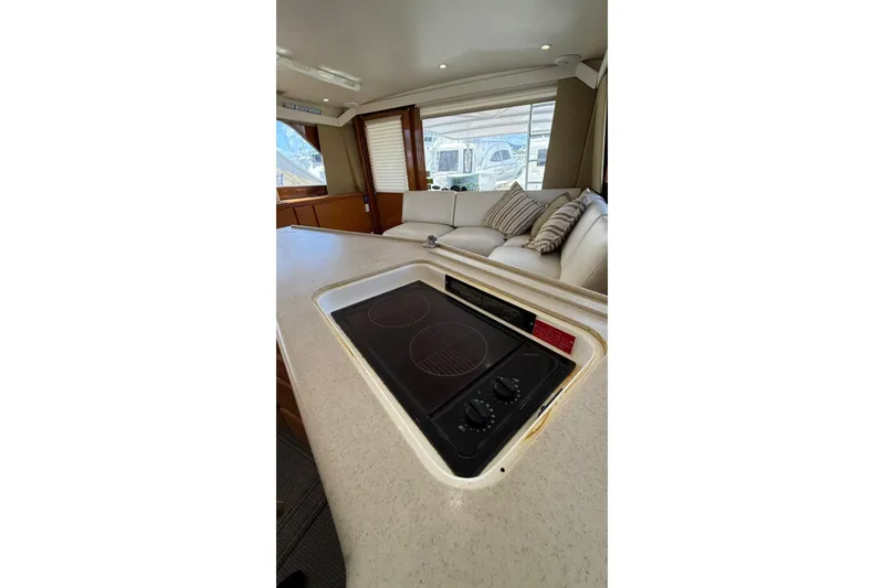 Slide: The Image of 1999 Viking 50 Convertible yacht interior with modern kitchen and cozy seating area. - 10