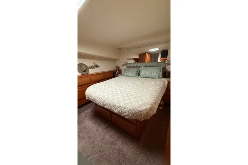 Slide: The Image of Luxurious bedroom interior of 1999 Viking 50 Convertible yacht with elegant bedding. - 12