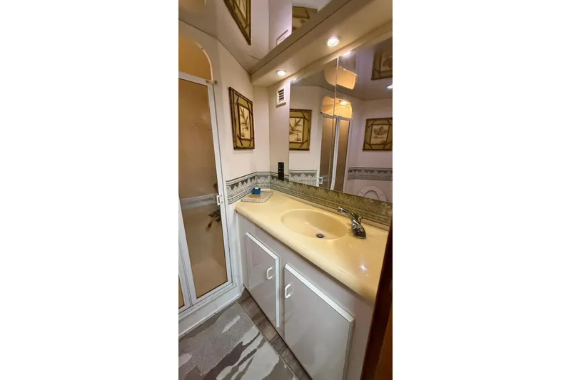 Slide: The Image of Bathroom interior of 1999 Viking 50 Convertible yacht with sink and shower. - 13
