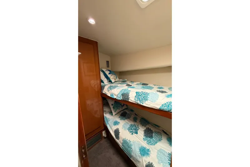 Slide: The Image of Bunk beds in 1999 Viking 50 Convertible yacht cabin with ocean-themed bedding. - 14