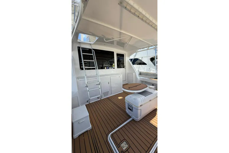 Slide: The Image of 1999 Viking 50 Convertible yacht deck with seating and storage. - 4