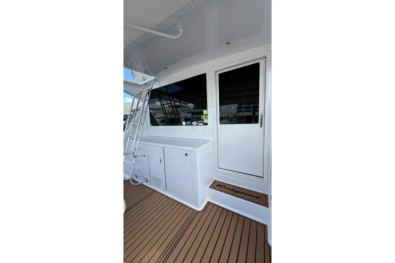 Slide: The Image of 1999 Viking 50 Convertible yacht with teak deck and white exterior. - 5