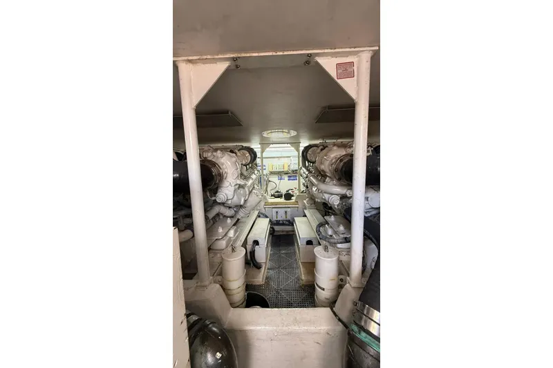 Slide: The Image of Engine room of 1999 Viking 50 Convertible yacht, showcasing dual engines and mechanical components. - 6