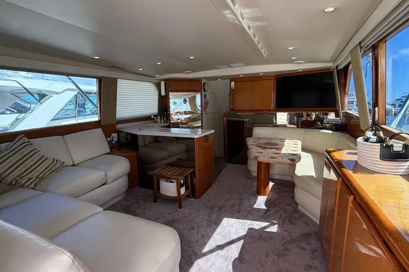 Slide: The Image of Luxurious interior of a 1999 Viking 50 Convertible yacht with plush seating and modern amenities. - 7