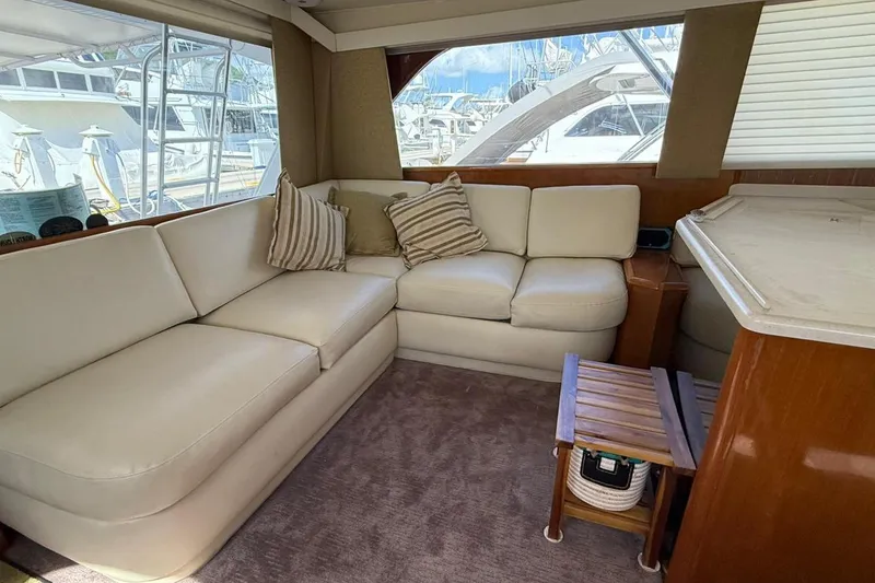 Slide: The Image of Interior of 1999 Viking 50 Convertible yacht with cream leather seating and striped cushions. - 8