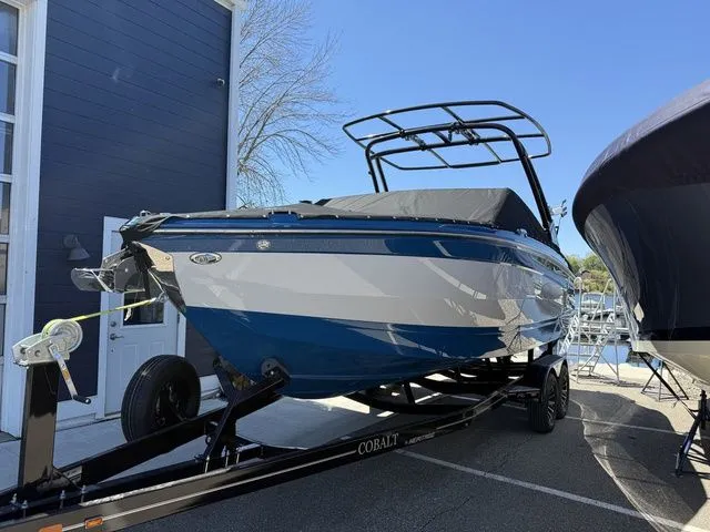 Slide: The Image of 2026 Cobalt R6 Surf boat on trailer, blue and white design. - 46