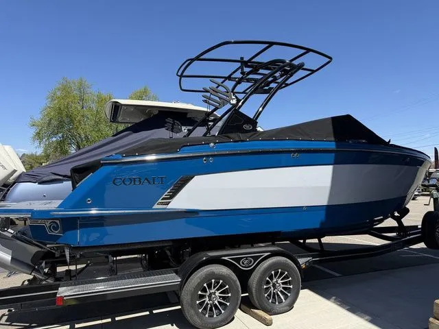 Slide: The Image of 2026 Cobalt R6 Surf boat on trailer, blue and white design. - 48