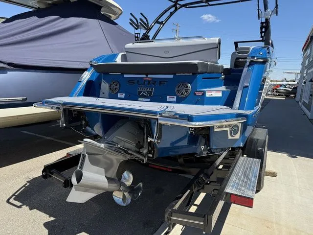 Slide: The Image of Rear view of a blue 2026 Cobalt R6 Surf boat on a trailer. - 6